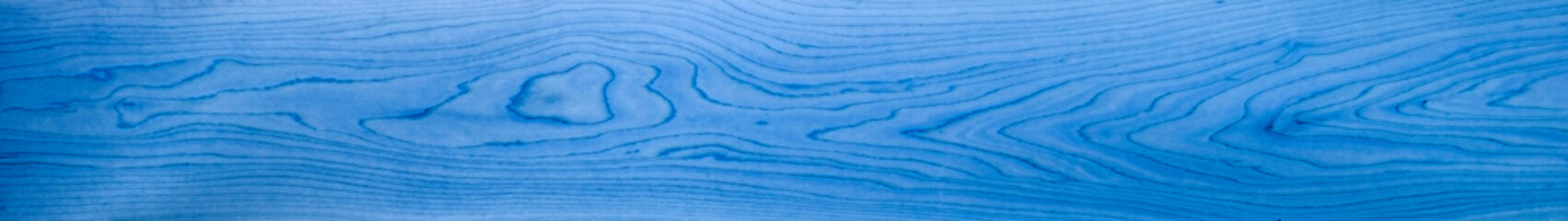 Blue wood panorama for banners, design, backdrops and headers - with abstract grain patterns, in a wooden background texture.