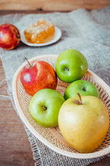 Honeycombs with honey and slices of ripe apples on wooden table.
