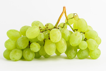 One bunch of ripe organic white grapes isolated on white background, side view