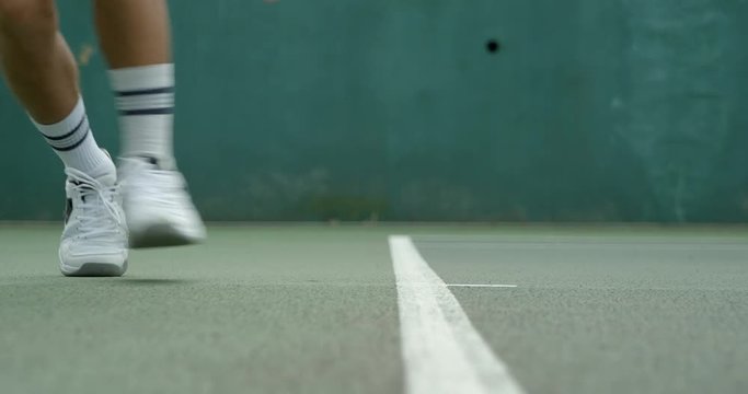 Close up of a Tennis Player returning a shot from the baseline