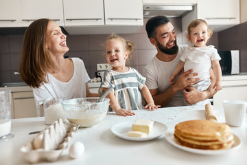 happy moments in the kitchen, close up photo, young cute family gets pleasure from spending time in the kitchen. close up photo