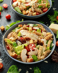 Caesar Salad Pasta with chicken, tomato, parmesan cheese and vegetables