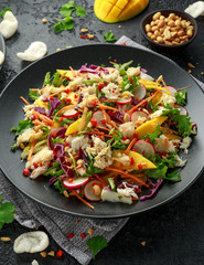 Crab salad with vegetables, radish, carrots, mango, pine nuts and prawn crackers