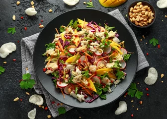 Tuinposter Crab salad with vegetables, radish, carrots, mango, pine nuts and prawn crackers © grinchh
