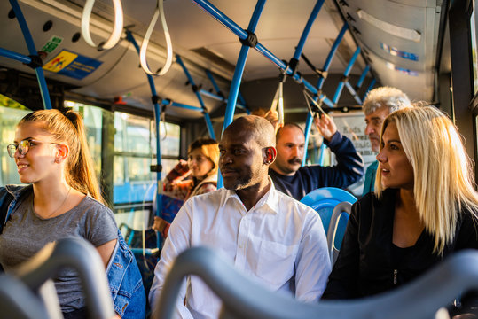 A multi-ethnic group of people enjoys public transportation - Powered by Adobe