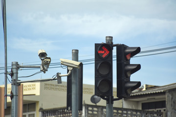 Red traffic light and CCTV Camera in the city street.