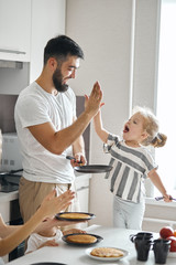 positive funny daddy and his kid giving high five to each other, rejoicing at yummy pancakes. close up photo. happiness - 292549585