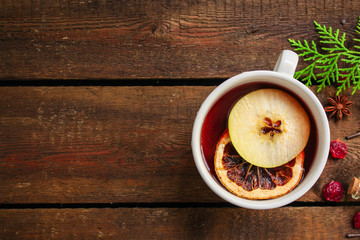 Christmas mulled wine on a wooden table. Traditional hot drink at Christmas (red wine with spices,...