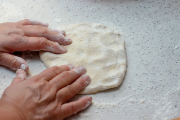 Making dough for homemade dumplings.