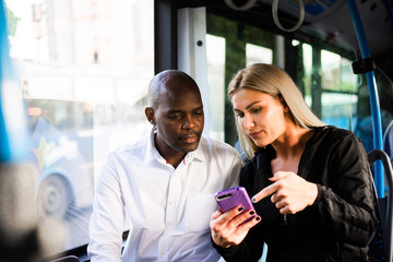 Cute young multicultural couple having fun in a public transportation
