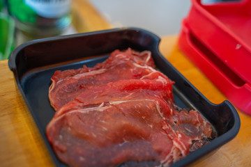 Peppered roast beef pastrami slices on black plate