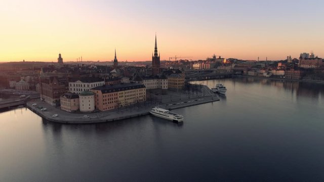 Aerial view of Stockholm skyline cityscape at sunrise. Drone shot flying over water, Riddarholmen island city buildings and church. Gamla stan, Old Town landmark, Capital of Sweden