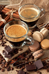 Composition with  coffee cup, coffee  beans and macarons cookies