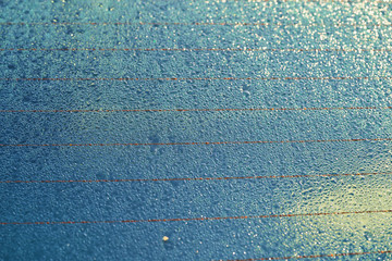 Dew drops on the car window. Beautiful background with water on the glass