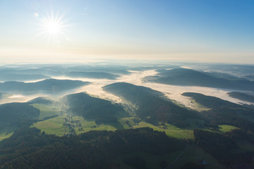 Fototapeta na wymiar Amazing landscape of the Black Forest in the morning with fog during sunrise, seen from a hot-air ballon, Hinterzarten, Germany