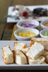 Bread toast and Thai custard on white plate.