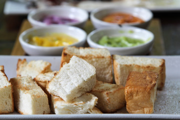 Bread toast and Thai custard on white plate.