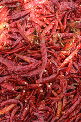 Fototapeta premium Top view of organic raw dried chillis ready for sale in the market.
