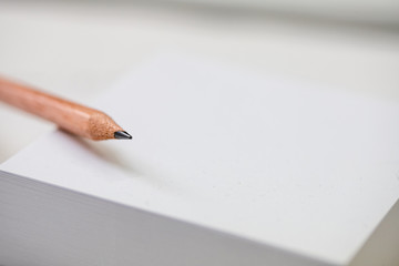 Nahaufnahme eines Bleistifts auf weißen Notizzetteln