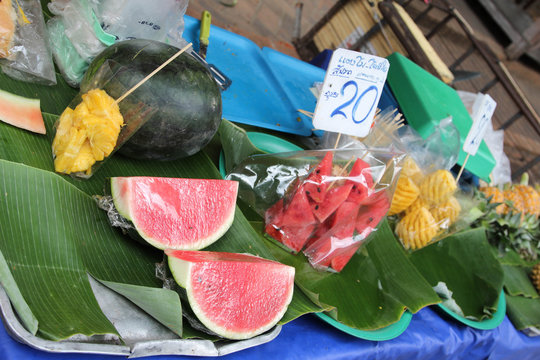 Ripe watermelon in clear plastic bag with tag price ready for sale.