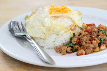 Thai food, stir-fried pork with basil and fried egg on rice