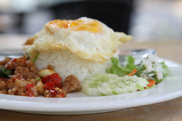 Thai food, stir-fried pork with basil and fried egg on rice