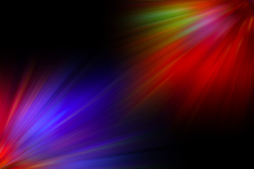 Multicolored rays of light shine of the black background