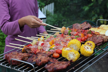 Barbeque Grill Street Food in thailand,Eat outdoors in a happy family.