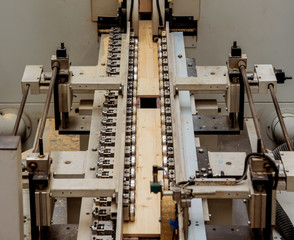 Production line of the wooden floor factory. CNC automatic woodworking machine.