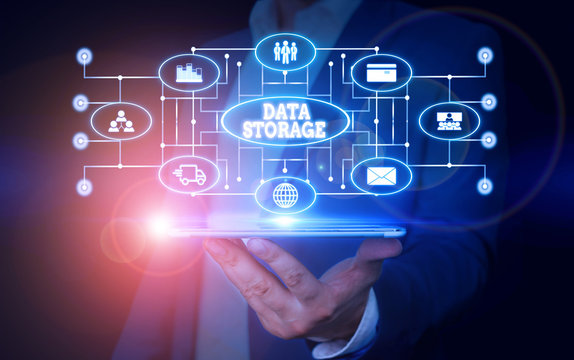 Conceptual hand writing showing Data Storage. Concept meaning the act of archiving data in electromagnetic or other forms Male wear formal suit presenting presentation smart device