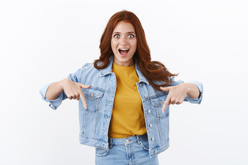 Awesome offer down there. Surprised enthusiastic redhead girl, look impressed and astonished,...