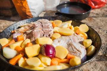 Sliced potatoes with onion and beef meat ready for baking