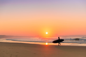 Naklejka na ściany i meble Surfer on the beach