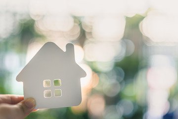 House model in home insurance broker agent ‘s hand or in salesman person. Real estate agent offer...