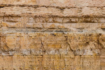 The layered structure of a rocky canyon wall, close-up.