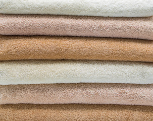 background wallpaper-close up of a stack of folded pastel bath towels