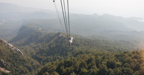 Mountain views from the cable car cabin to the top of Tahtali and the sea near the coast of Kemer, Antalya, Turkey