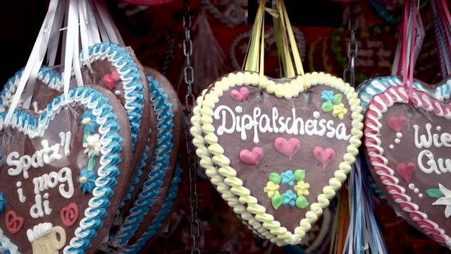 Side pan of gingerbread heart in munich Oktoberfest typical tourist souvenir from bavaria city. German text is reading "i like you" in traditional bavarian slang language "i mog di"