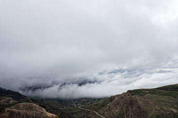 landscape of descending fog from mountain to village