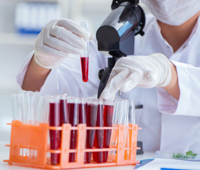 Female scientist researcher conducting an experiment in a labora