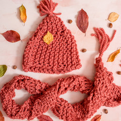 Autumn related accessories on the white. Hat, scarf, cup of coffee and other small objects, top view