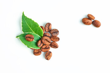 Coffee beans and leaves isolated on white background, closeup. Top view.