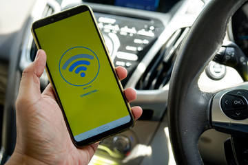 A man hand holding smartphone with  wifi searching on the screen. Wi-fi is the current generation Wi-fi connectivity with high capacity, coverage and performance.