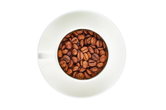 White coffee Cup with coffee beans on saucer isolated on white background. Top view.