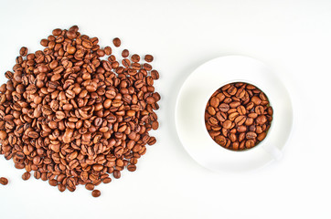 Background of a hill of coffee beans and a coffee Cup and saucer.