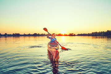 People kayak during sunset in the background. Have fun in your free time. © 6okean