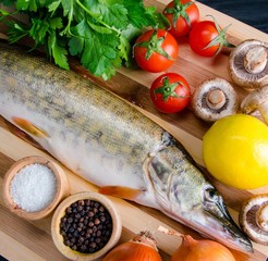 Uncooked fish on cutting board in meal preparation concept