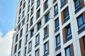 Modern luxury urban apartment building exterior with blue sky