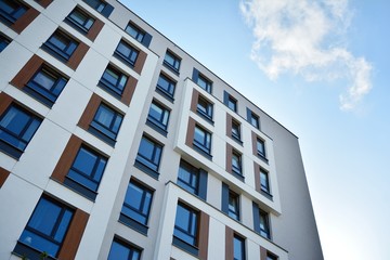 Modern luxury urban apartment building exterior with blue sky