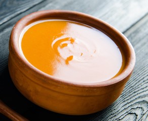 Carrot soup served on the table in bowl